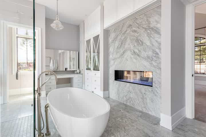 Custom white marble bathroom remodel with fireplace in Glendale, California